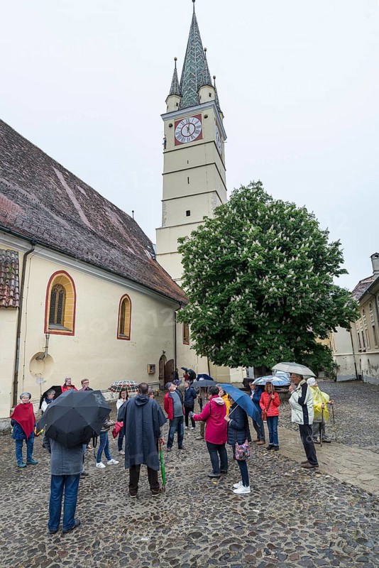 Tour group in the courtyard of St. Margaret's Church, Medias, Romania
