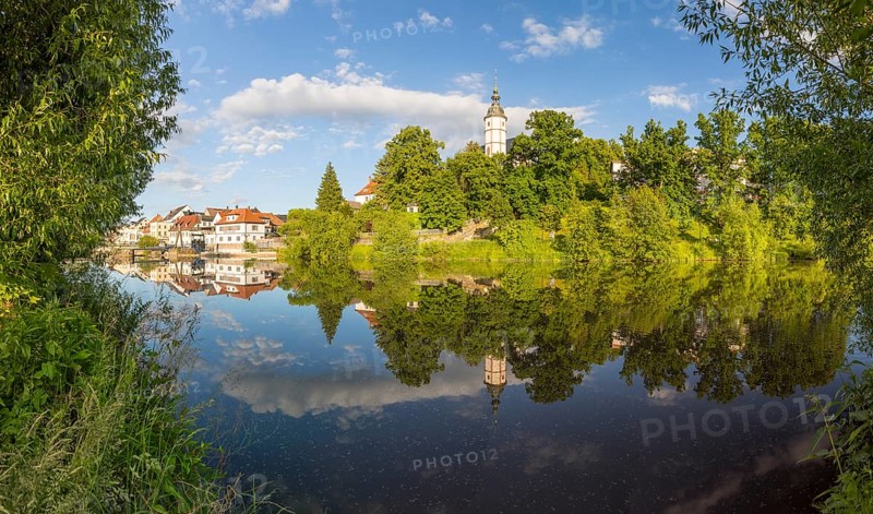 Panorama of city view with church of Our Lady on the mountains and reflection in Zwickauer Mulde, Penig, Saxony, Germany