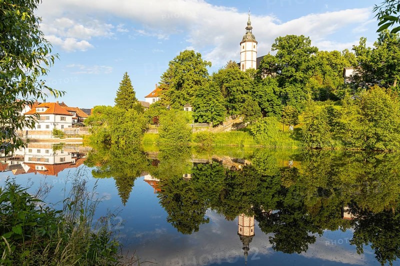 City view with church of Our Lady on the mountains and reflection in Zwickauer Mulde, Penig, Saxony, Germany