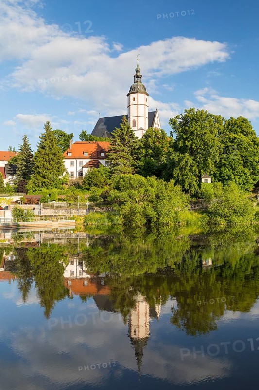City view with church of Our Lady on the mountains and reflection in Zwickauer Mulde, Penig, Saxony, Germany
