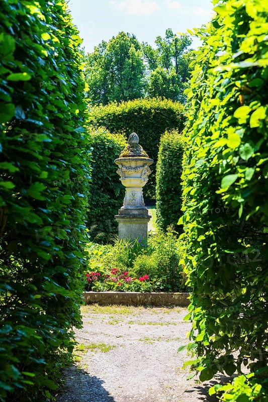 Visual axis through arcades to an ornamental sandstone vase, Pulsnitz Castle Park, Saxony, Germany