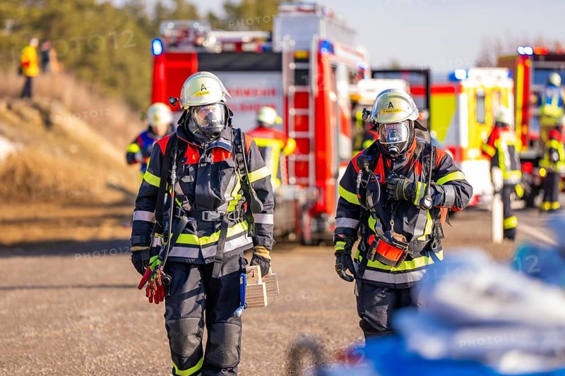 Two firefighters with respirators and full equipment on duty, fire brigade exercise on the Hermann Hesse railway, Ostelsheim, Germany