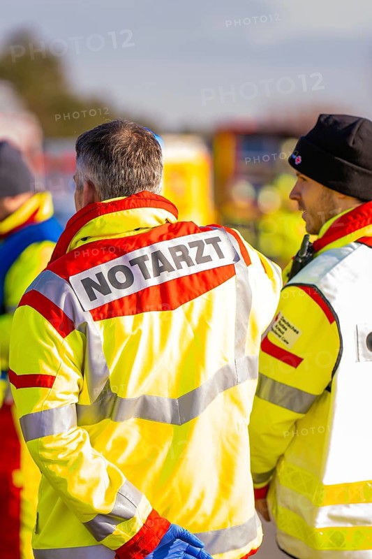 Rescue team wearing operational clothing in an emergency situation on a road, fire brigade exercise on the Hermann Hesse railway, Ostelsheim, Germany