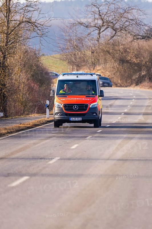 An ambulance drives along a winding country road, fire department exercise on the Hermann Hesse railway, Ostelsheim, Germany