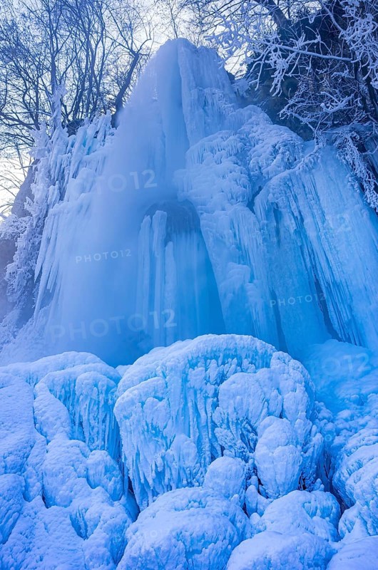 Urach waterfall full of bizarre ice formations frozen at winter temperatures, Bad Urach, Swabian Jura, Baden-Württemberg, Germany