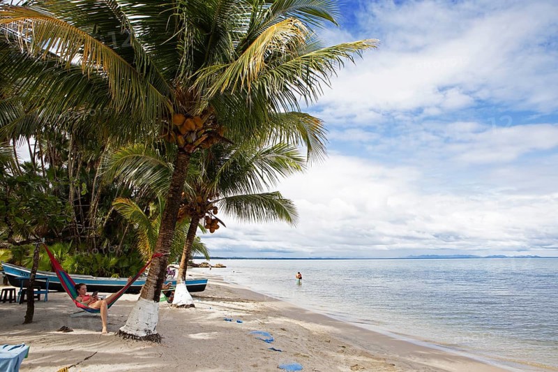Sandy beach beach and coconut trees on Playa Blanca, Izabal Department, Guatemala