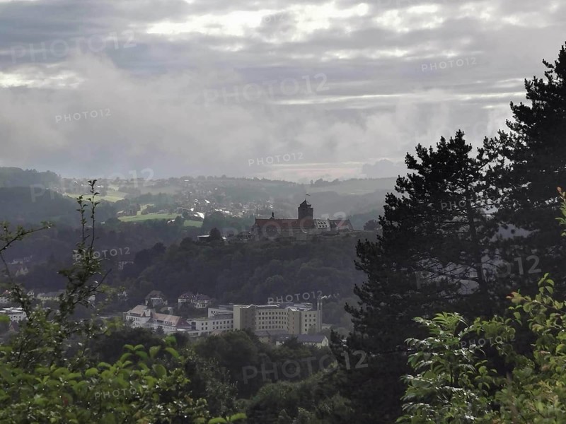 Fortress on a hill in fog with a view of a wide landscape, view over Kronach, Frankenwald nature park Park