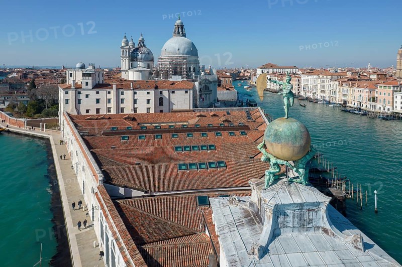 Drone footage of the Dogana da Mar, moving wind vane of Saint Fortuna on a gilded globe carried by atlases, Grand Canal, Venice, Veneto, Italy