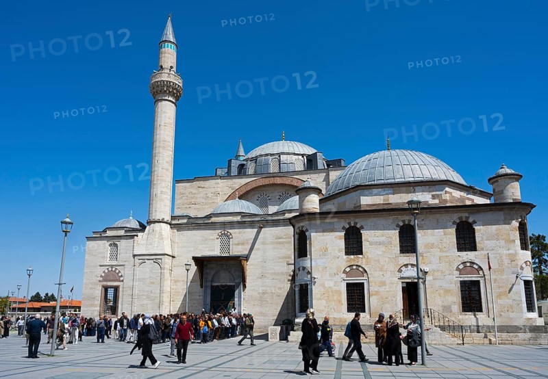 Visitors enter a historic mosque with several domes and minarets, prayer in front of the mosque, Konya Sultan Selim Camii, Konya, Central Anatolia, Turkey
