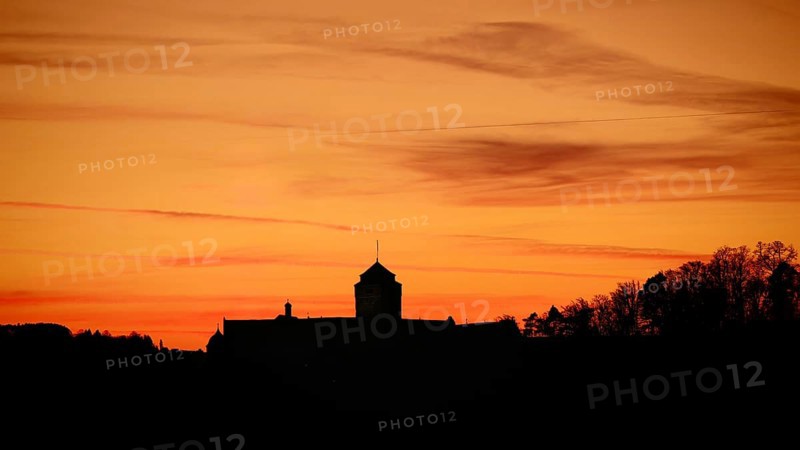 Silhouette of a castle at sunset, warm tones above the horizon, view of Rosenberg Fortress, Kronach, Frankenwald nature park Park
