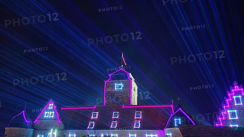 Impressive laser light show over a castle at night, Kronach glows, Frankenwald nature park Park