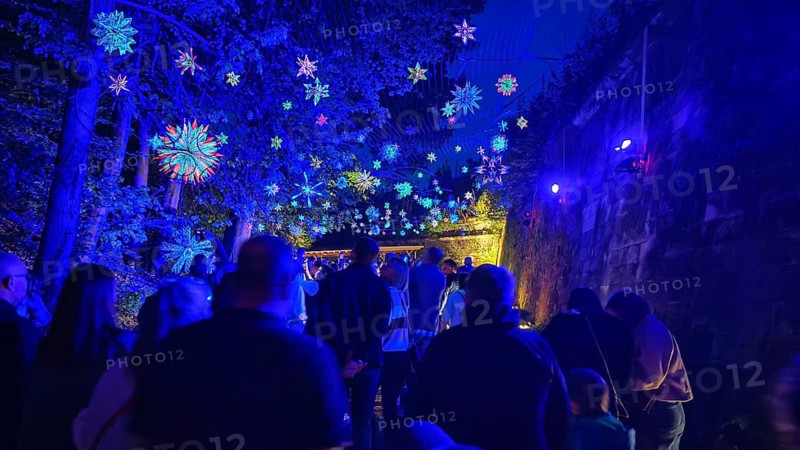 Night atmosphere with magical blue lights and people at a party, Kronach glows, Frankenwald nature park Park