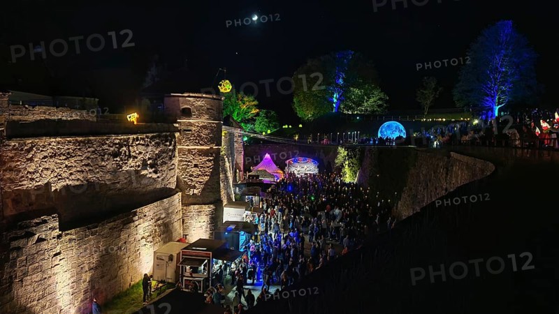 Festival atmosphere in an illuminated castle at night with many visitors, Kronach glows, Frankenwald nature park Park