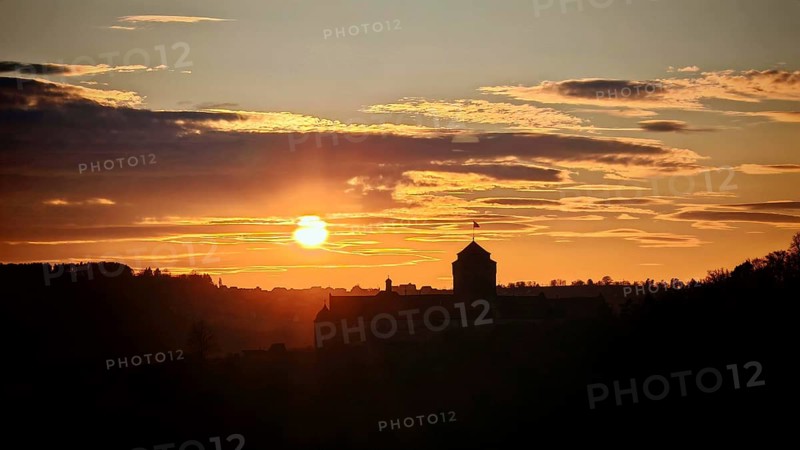 Sunset behind a castle, the silhouette is visible in the sky, view of Rosenberg Fortress, Kronach, Frankenwald nature park Park
