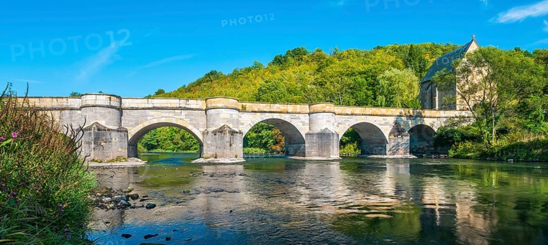 13th century medieval stone bridge across the Werra river, in the back the Liborius chapel, Creuzburg, Thuringia, Germany