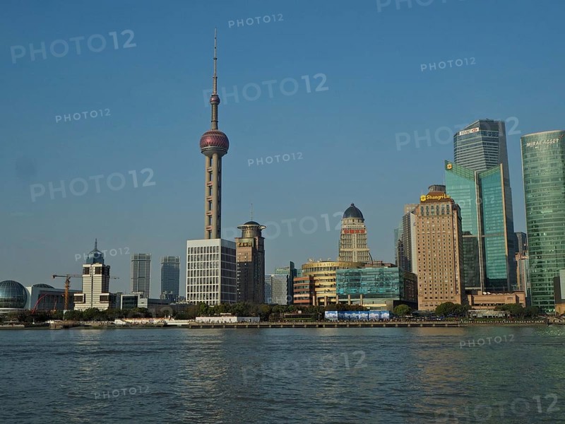 Panorama of a modern skyline of Huangpu Jiang with television tower and water in the foreground, Pudong, Shanghai, China