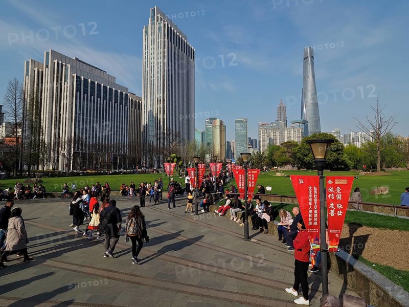 A busy municipal park with people and skyscrapers, Shanghai Tower, in the background, Shanghai, China