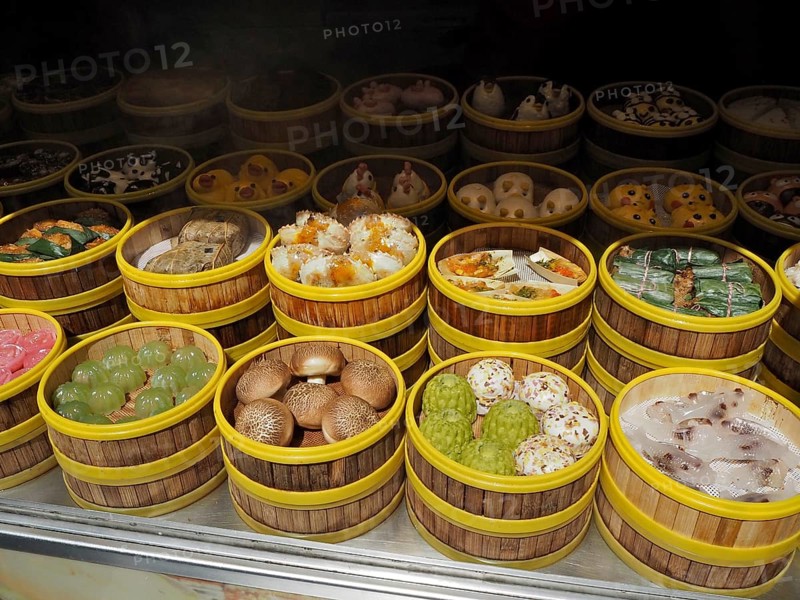 Different types of dim sum carefully arranged in bamboo steamers at a wet market, French Concession, Shanghai, China