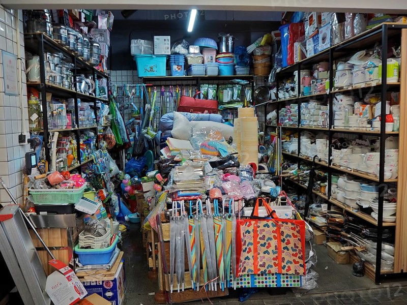 Small shop with a variety of everyday items on densely packed shelves and tables, Wet Market, French Concession, Shanghai, China