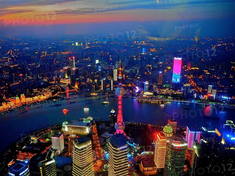 Colorful skyline lights at sunset with river in the foreground, Shanghai, China
