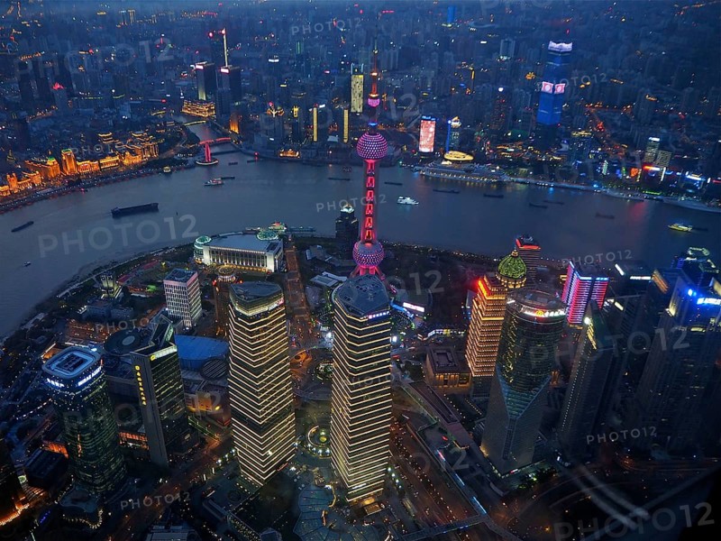View of illuminated skyscrapers and river at night, Shanghai, China