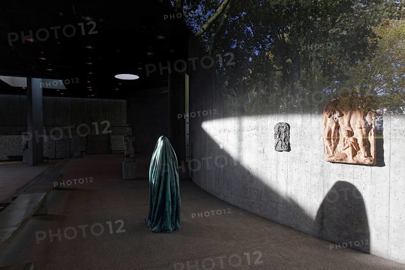 Statue of a veiled figure in the Lehmbruck Museum, looking through window, self-portrait as a ghost by sculptor Alicja Kwade, Duisburg, North Rhine-Westphalia, Germany