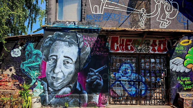 Colourful graffiti portrait on an urban wall with further figures and details, Ljubljana, Slovenia