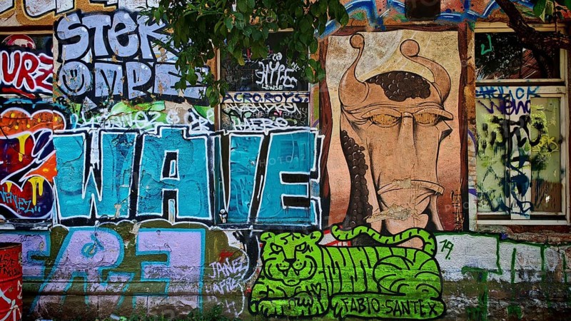 Colourful graffiti with various motifs on a brick wall in an urban environment, Ljubljana, Slovenia