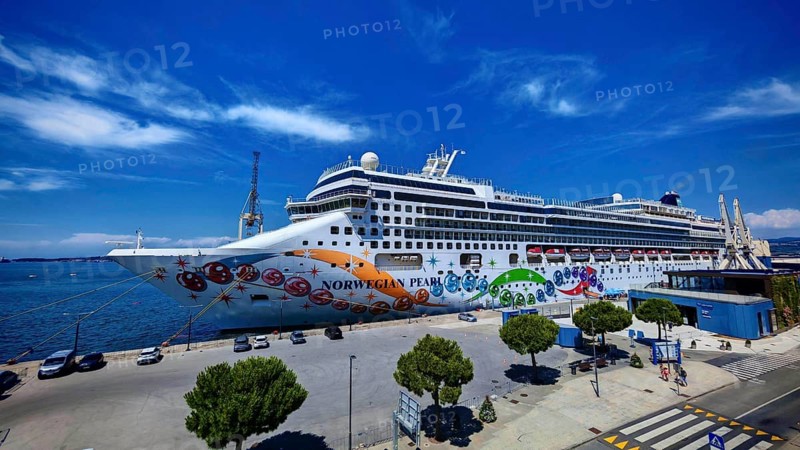 A large cruise ship is moored in the port of Koper under a clear blue sky, Slovenia