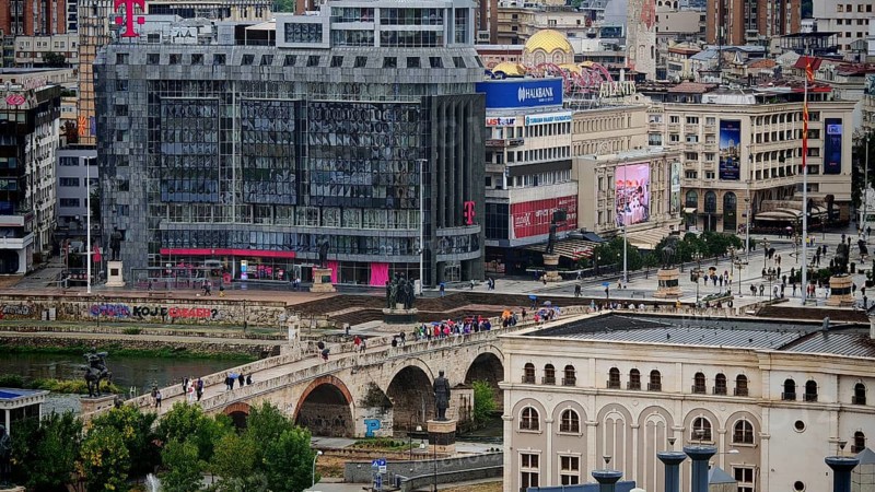 View of a city with a modern building and a bridge, Skopje, North Macedonia