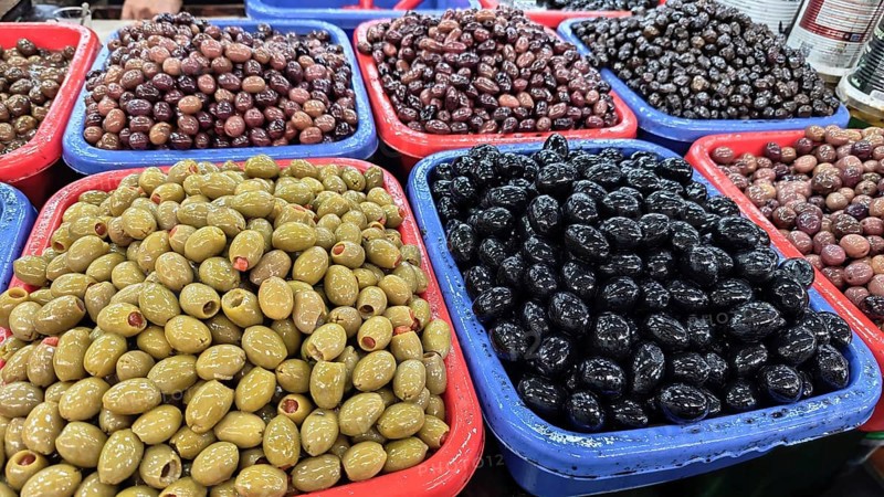 Colourful containers with different types of olives (olivae) at a market, Skopje, North Macedonia