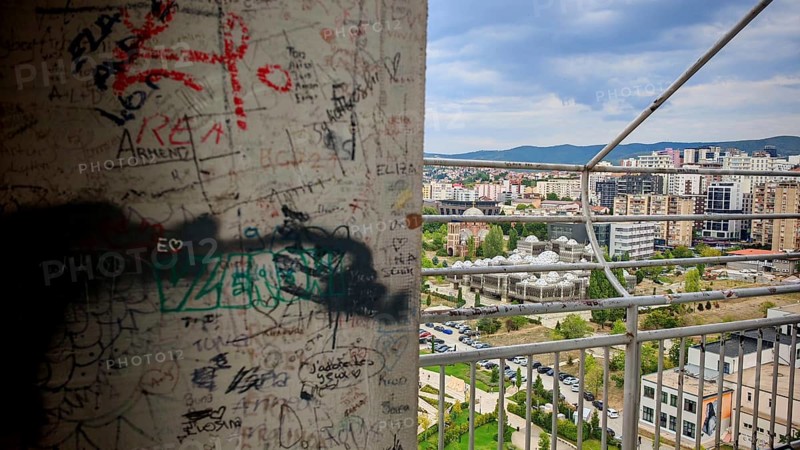 Wall with graffiti and cityscape in the background, Pristina, Kosovo