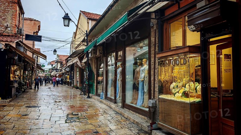 An old town alley with shops and wet pavement, Ohrid, North Macedonia
