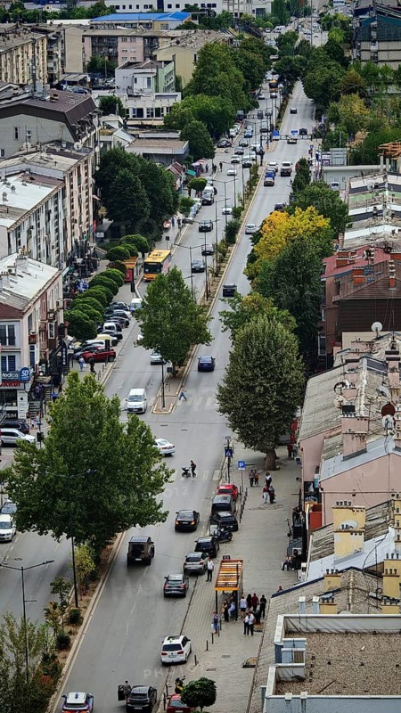 Aerial view of busy urban street with trees and vehicles, Pristina, Kosovo