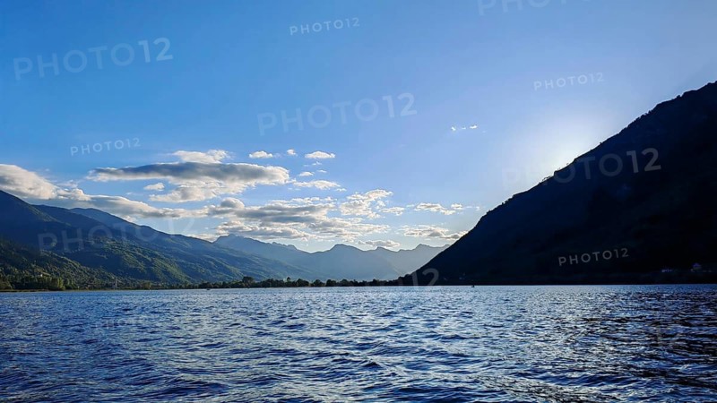 View of a lake with mountains in the background and a clear blue sky, Plav Lake, Montenegro