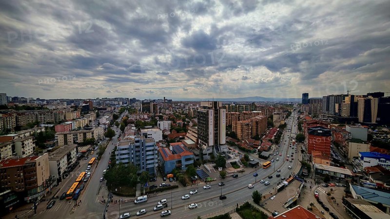 City view with busy streets, buildings and cloudy sky, Pristina, Kosovo
