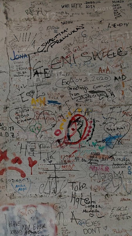 Colourful graffiti and doodles cover a wall, Pristina, Kosovo