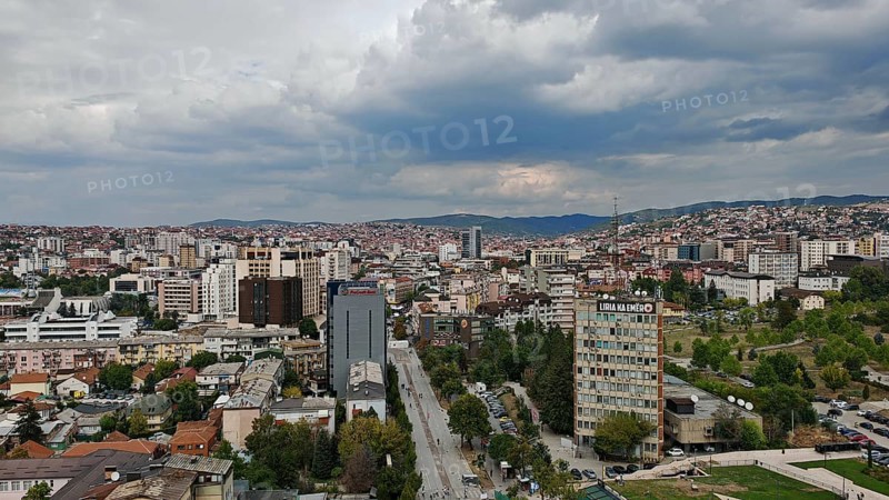 Panoramic view of a city with thick clouds in the sky, Pristina, Kosovo