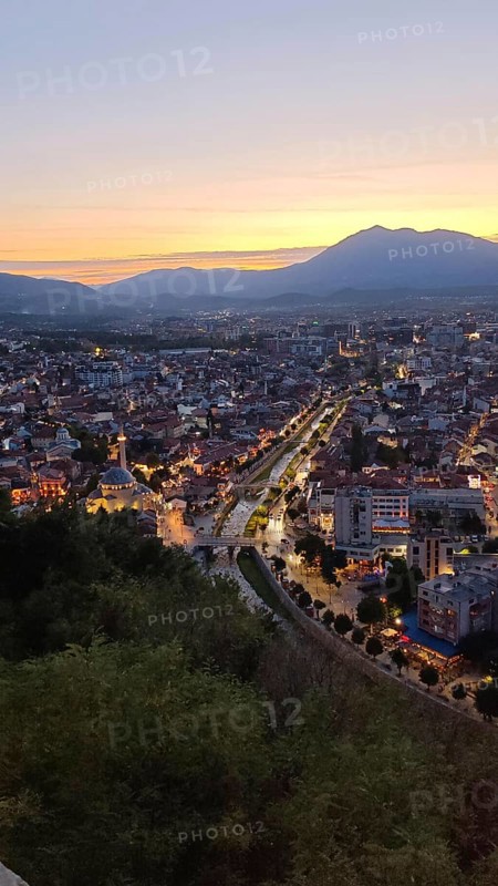Evening panoramic view of the city with illuminated streets and river, Prizren, Kosovo
