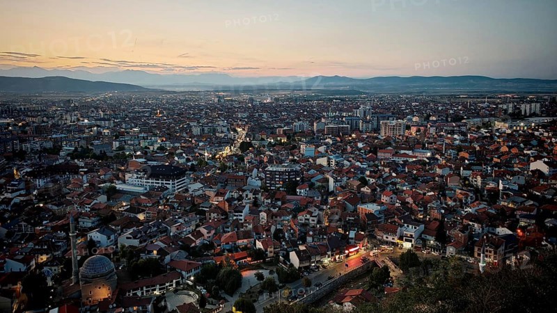 Extensive night view over the city with illuminated roads and hills, Prizren, Kosovo