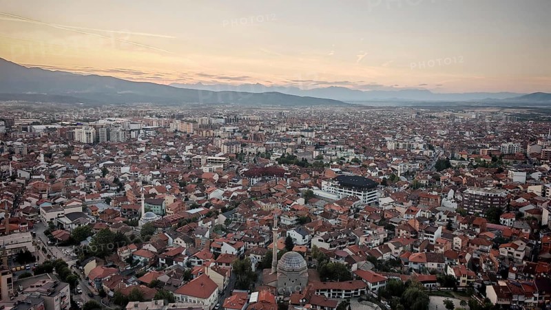Extensive view of the city in evening light with mosque and mountains on the horizon, Prizren, Kosovo