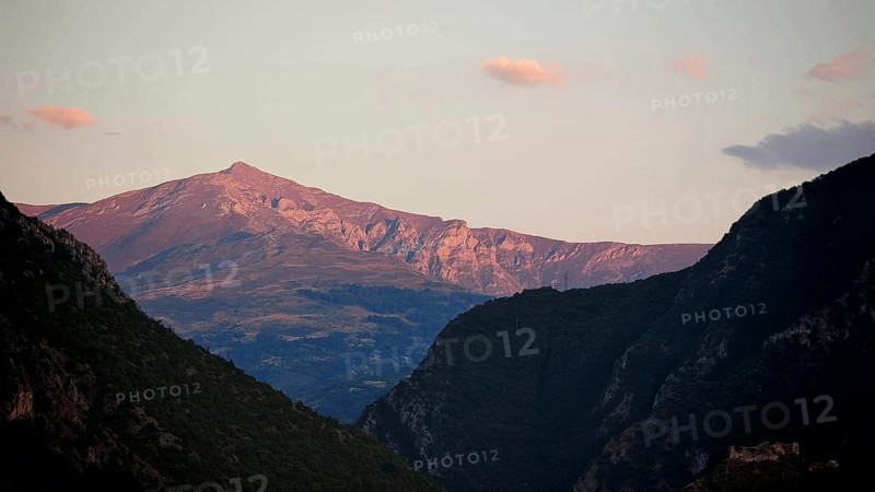 Mountain landscape in evening light with cloudy sky and rolling hills, Prizren, Kosovo