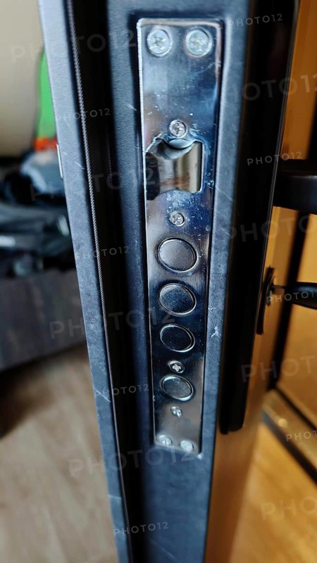 Closeup view of metal door lock with multiple locking bolts, security in hotel, Kosovo