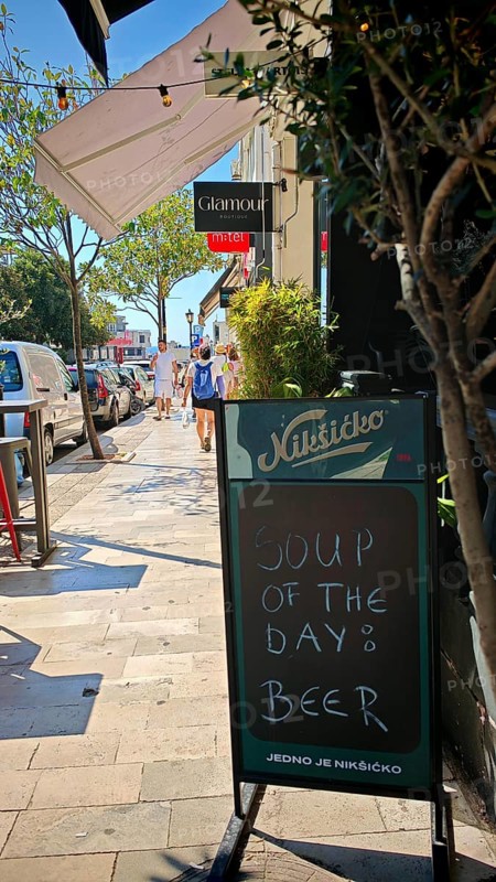 Funny street sign Chalkboard signs outside a café offering beer as soup of the day on a sunny day, Montenegro