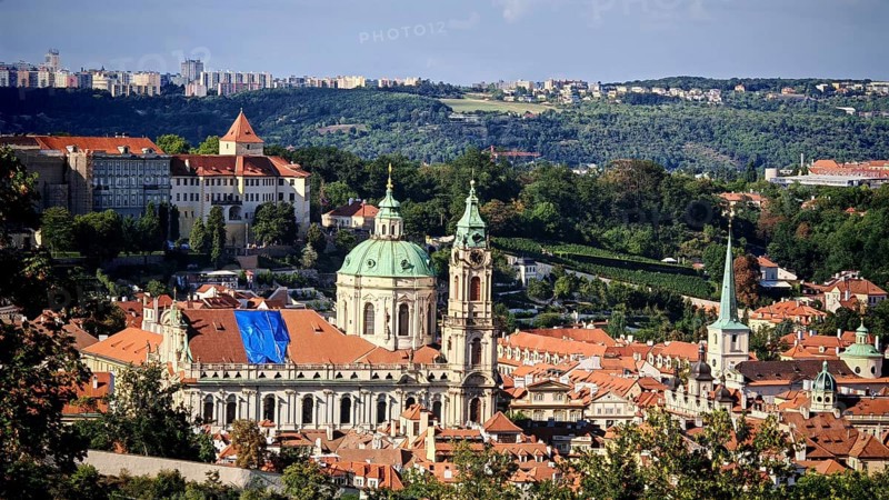 View of a Baroque church and surrounding cityscape with sunny sky, Prague, Czech Republic