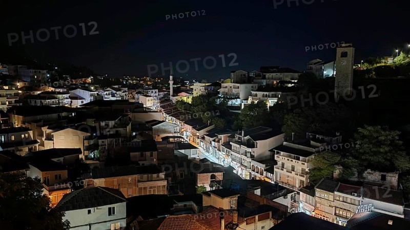 Night view of illuminated cityscape with houses and roads in darkness, Montenegro