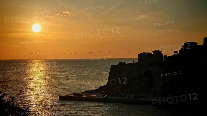 Sunset over ocean with golden colors and silhouettes, Ulcinj, Montenegro