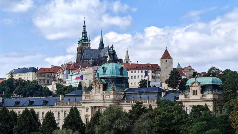 Historic buildings and towers under blue sky in an urban landscape, view of Hradcany, Prague Czech Republic