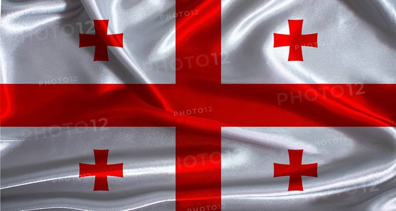 Georgia flag with cloth textured background. National flag of Georgia with realistic texture
