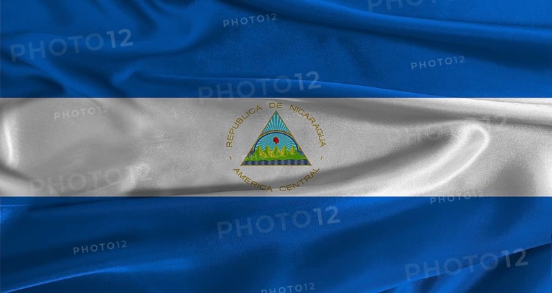 Flag of Nicaragua with fabric textured background. Close up of National flag of Nicaragua with realistic texture